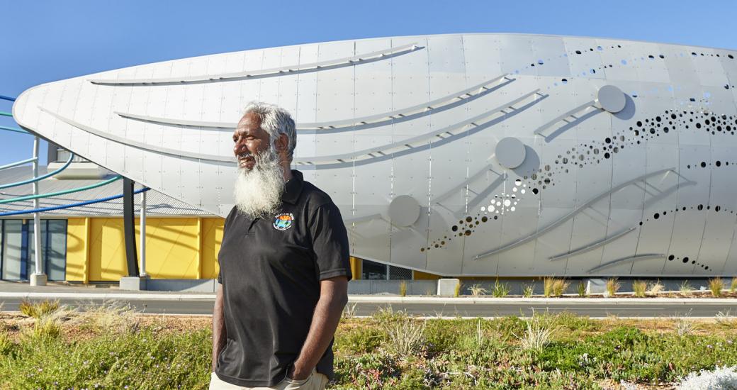 Aboriginal artist Troy Bennell standing in front of the new Dolphin Discovery Centre