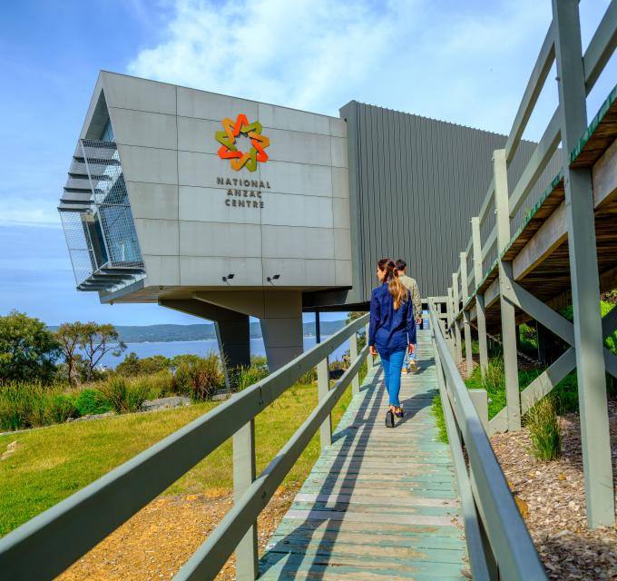 A woman walks along a boardwalk up to the National Anzac Centre in Albany